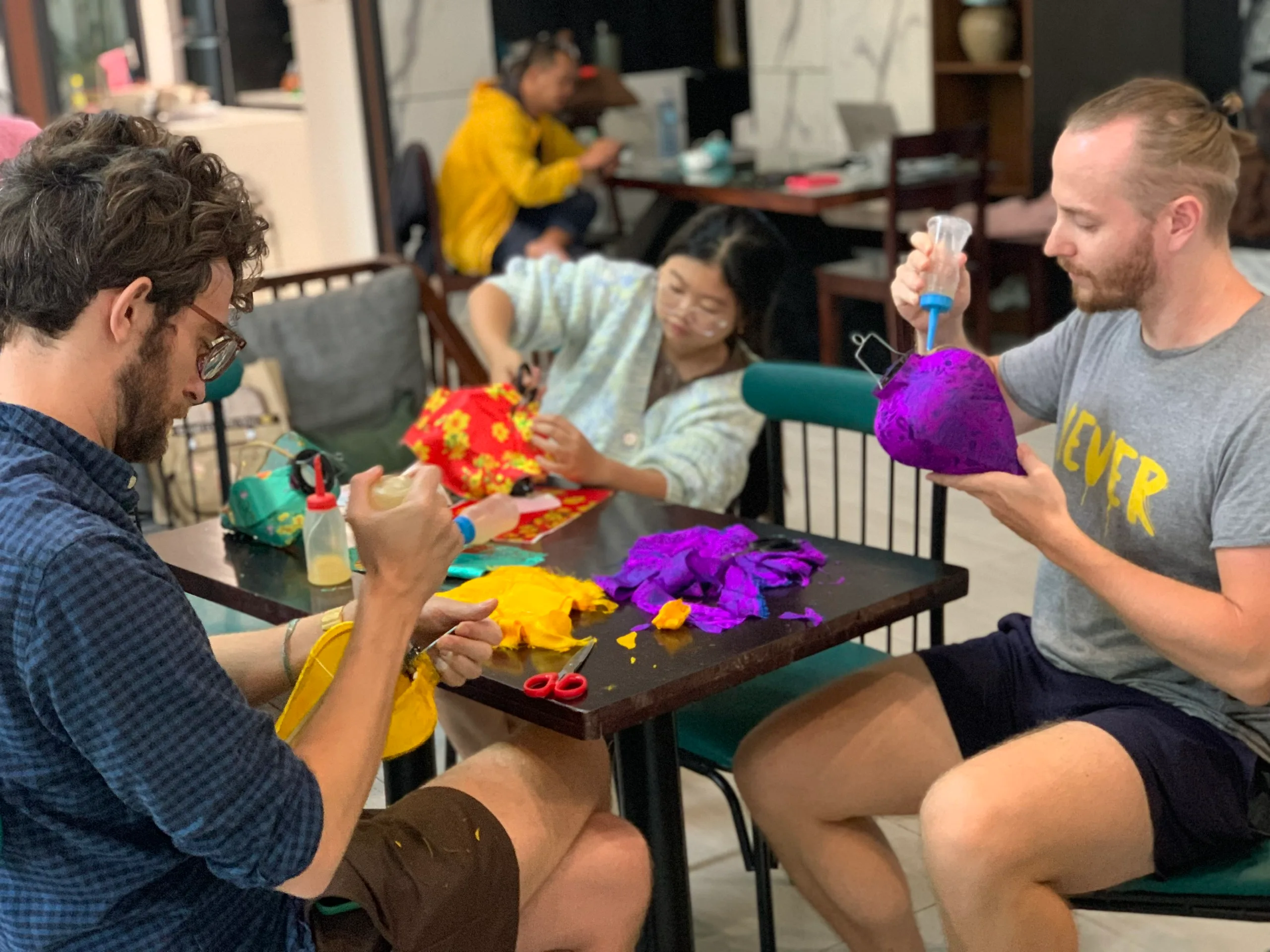 Babysitter supporting siblings with creative Lantern-making activitie