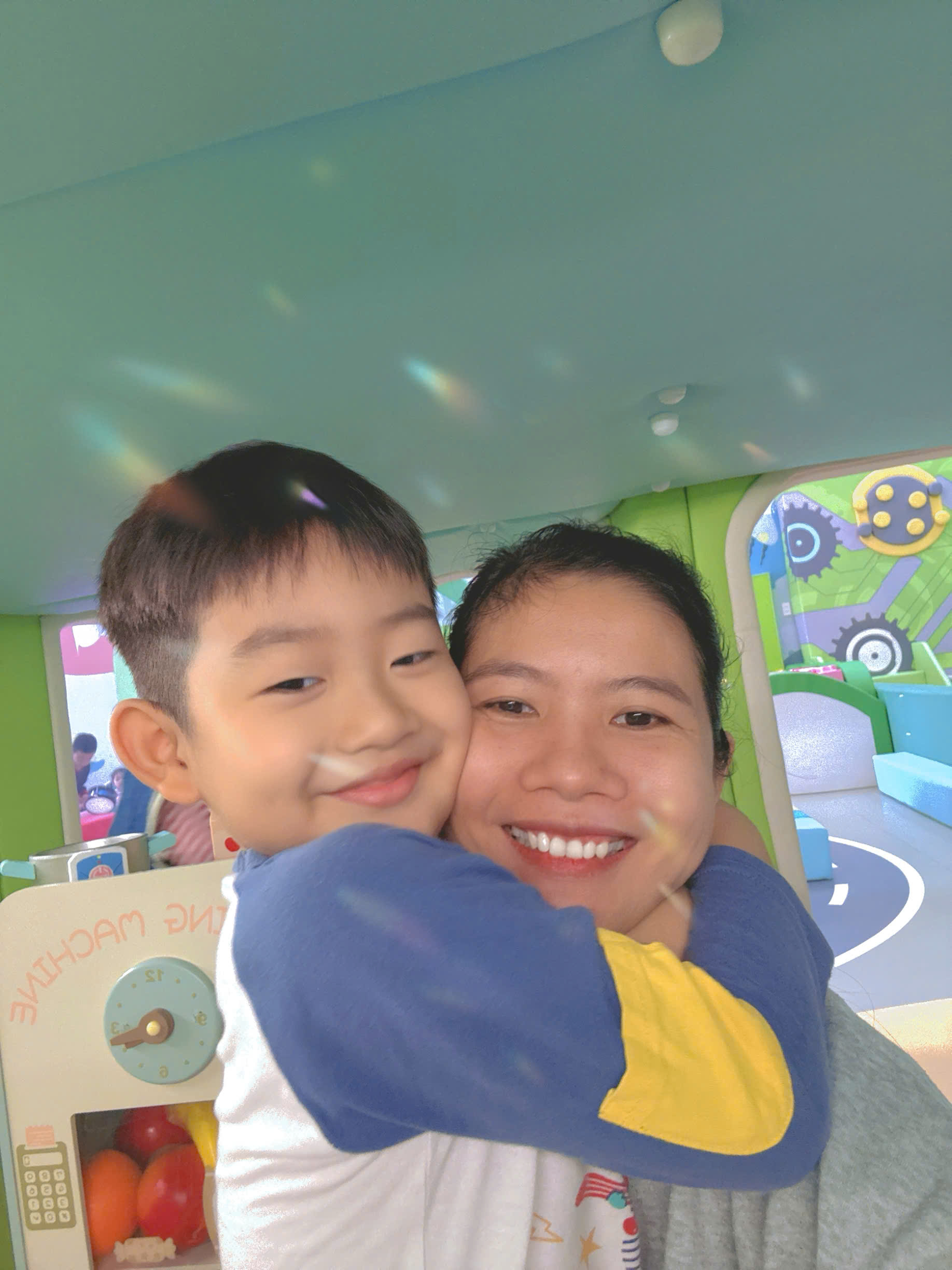 Babysitter playing with a child at a kids park (supervised play)