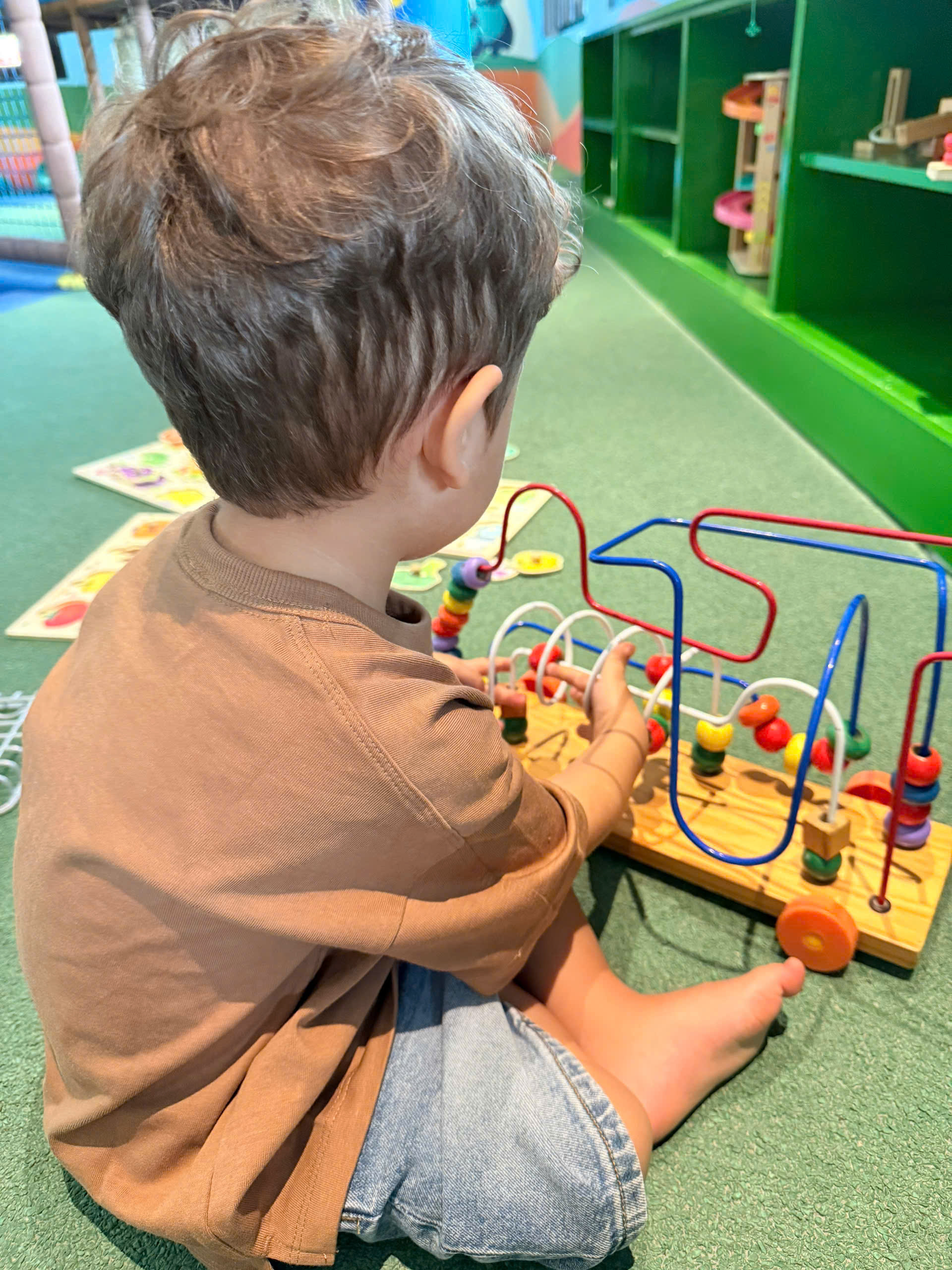 Babysitter playing with a child at a kids park in Da Nang
