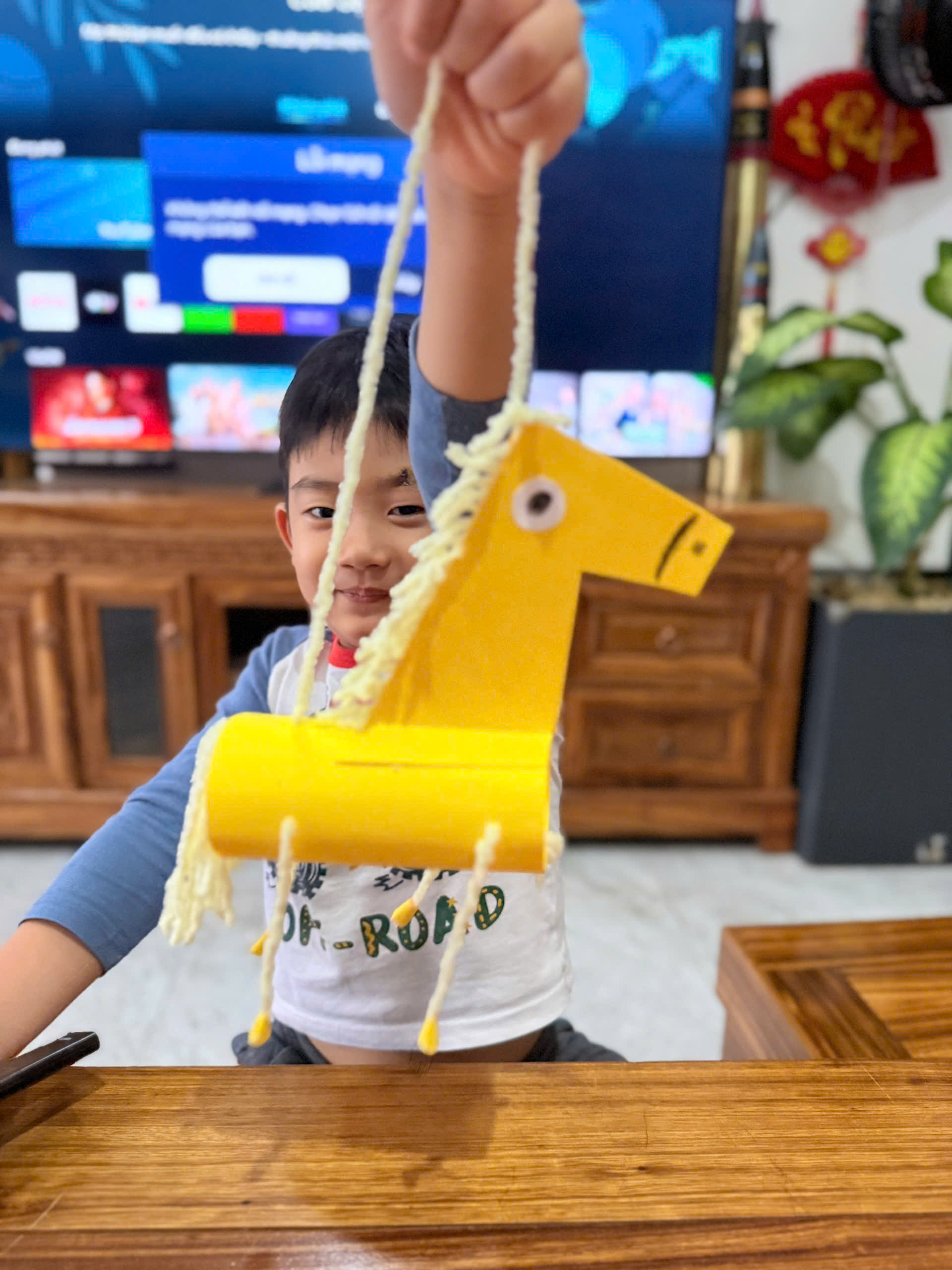 Babysitter helping a child enjoy a creative craft activity