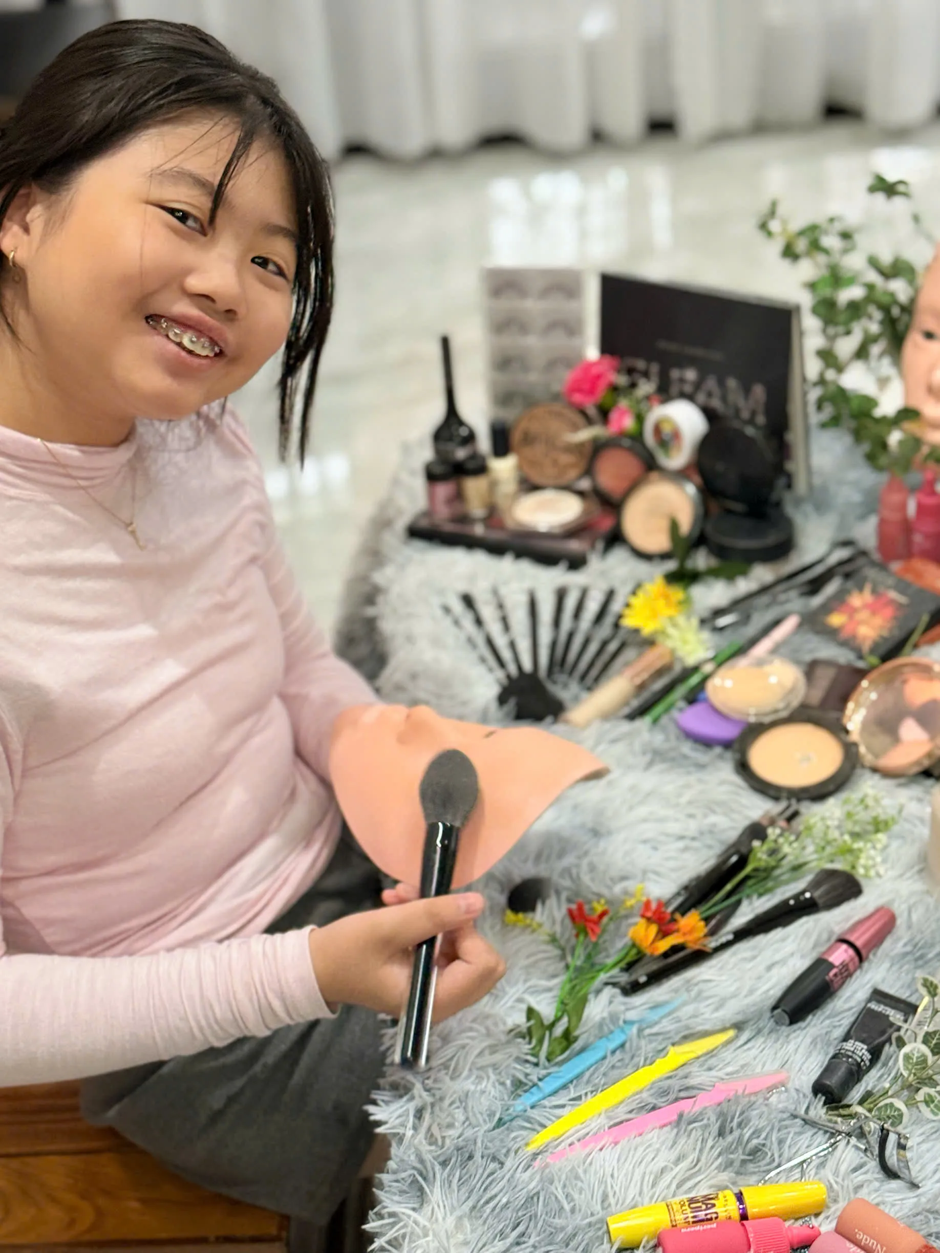 Babysitter guiding a child to do kid-safe mini makeup on a mask during daily babysitting