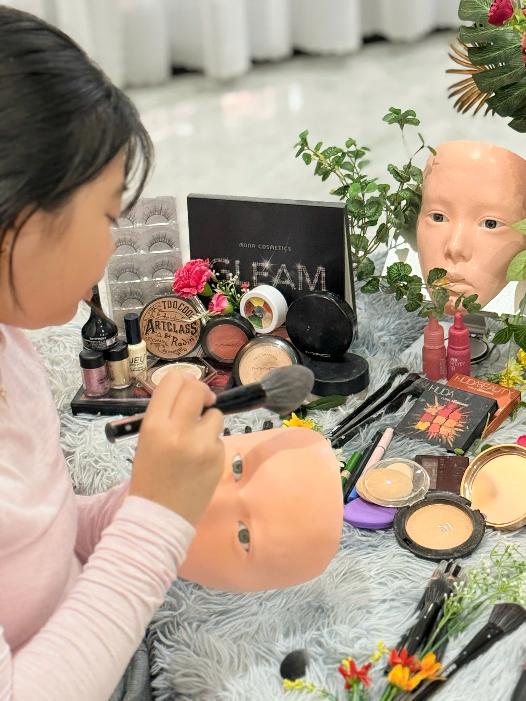 Child completes mini makeup on a mask after babysitter guidance during full-day childcare