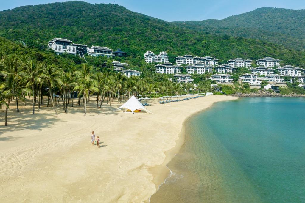 Calm babysitter spending quiet indoor time with a child during a luxury resort stay in Da Nang