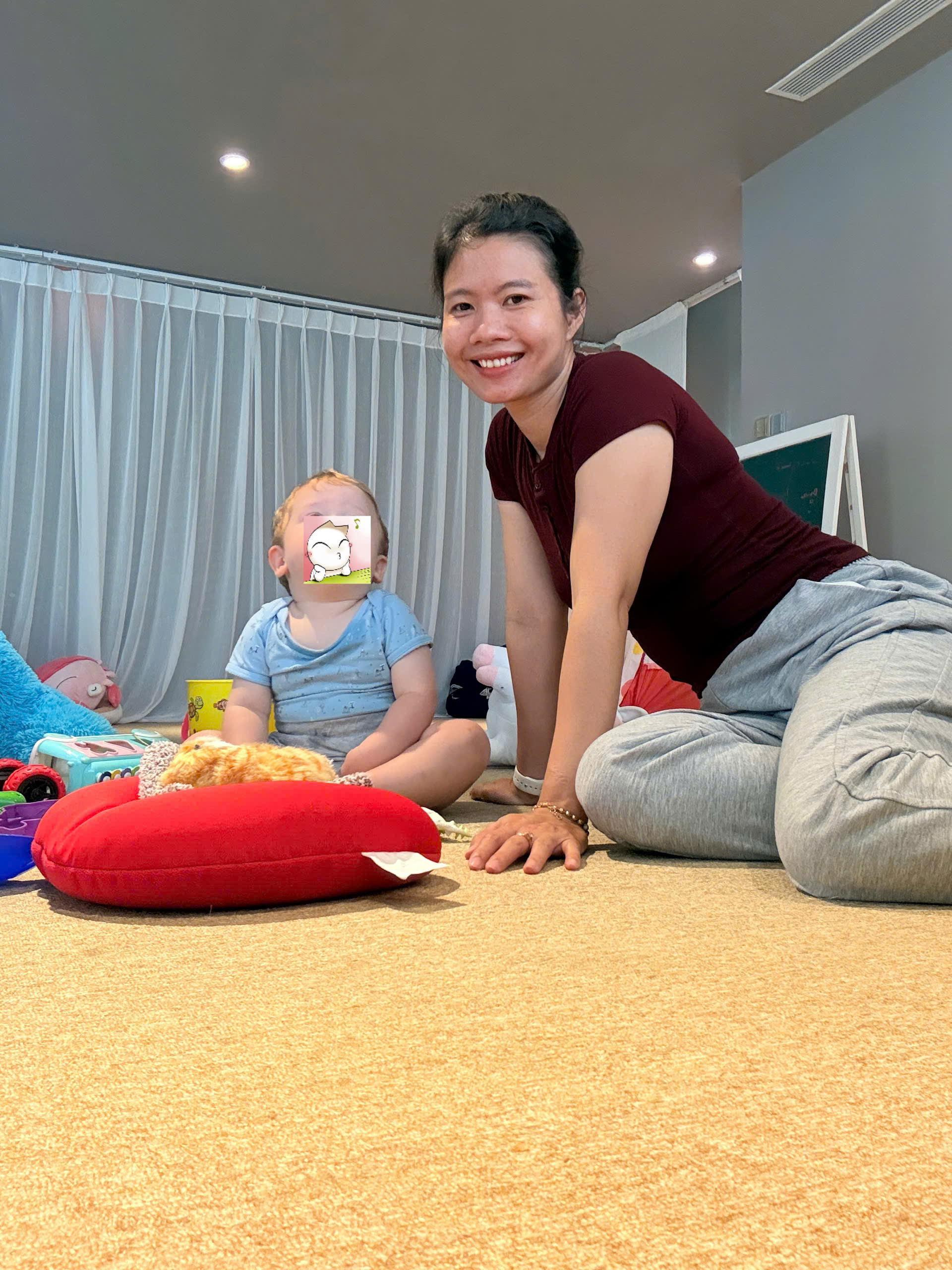 Babysitter at Almanity Hoi An Wellness Resort playing gently with a toddler in a calm resort room
