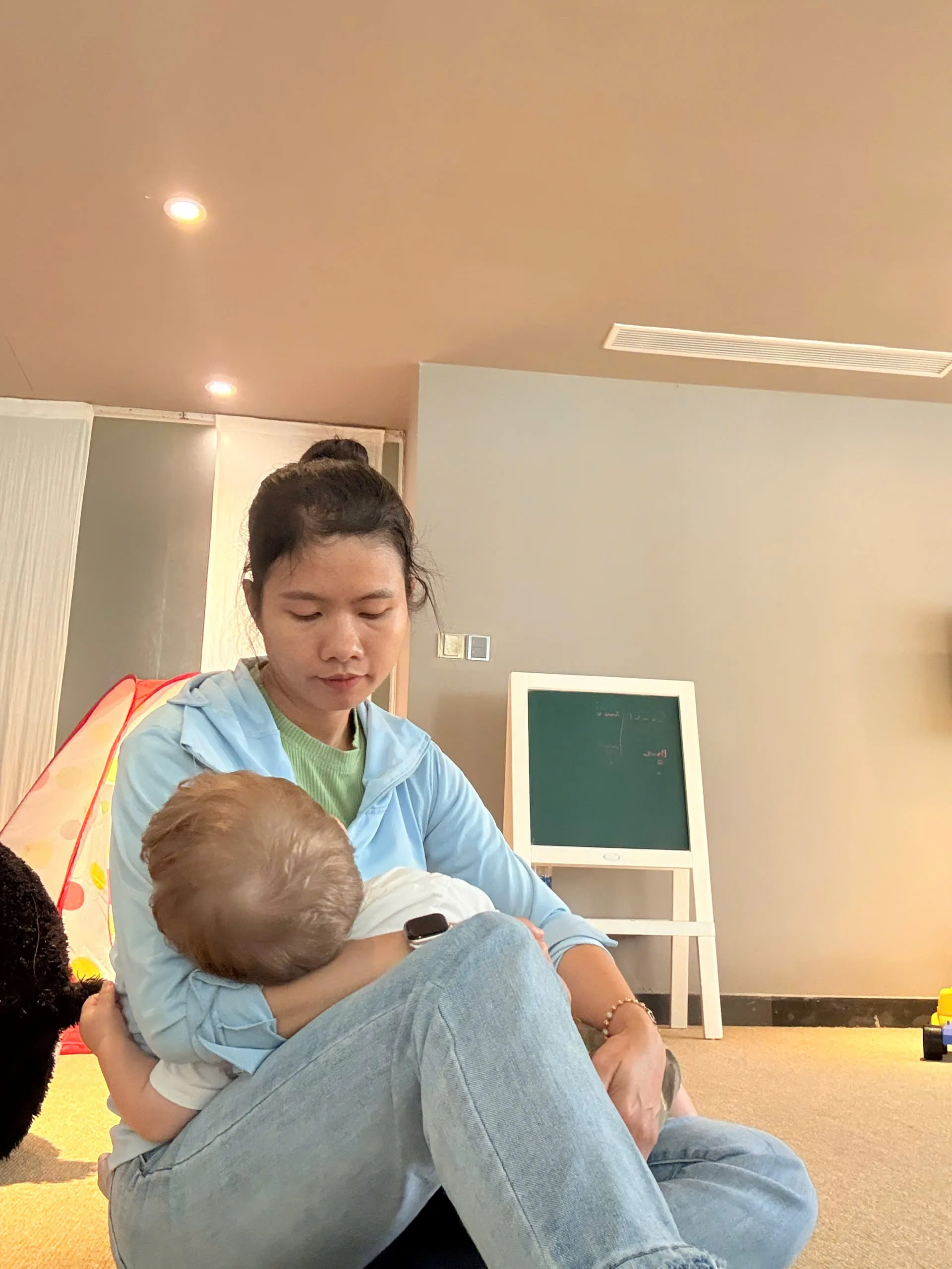 Nanny reading bedtime story to kids at Vietnam beach resort