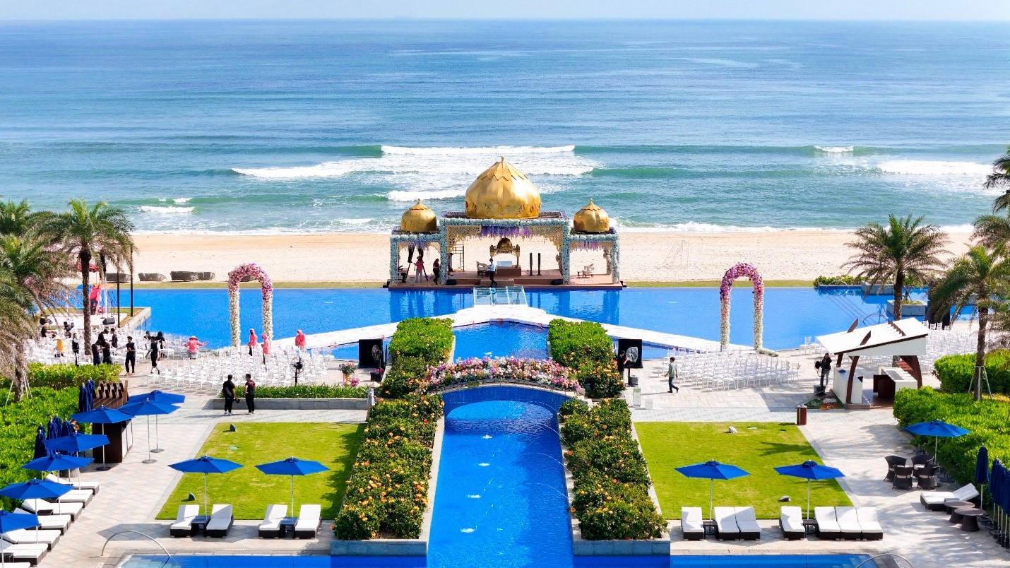 babysitter at Sheraton Grand Danang helping a toddler feel safe during a calm resort walk