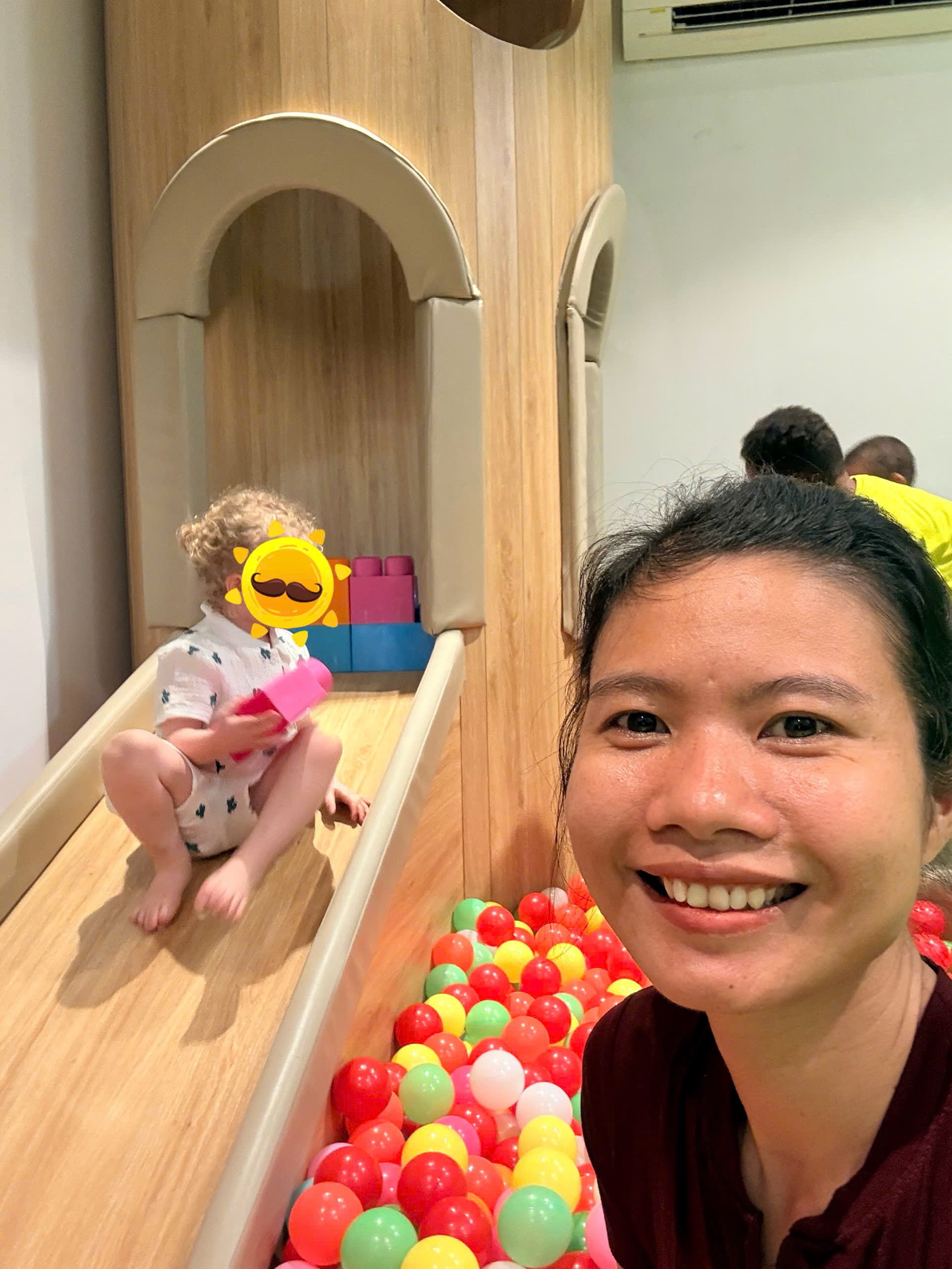 English-speaking babysitter at TIA Wellness Resort helping a child feel safe and relaxed in a calm setting