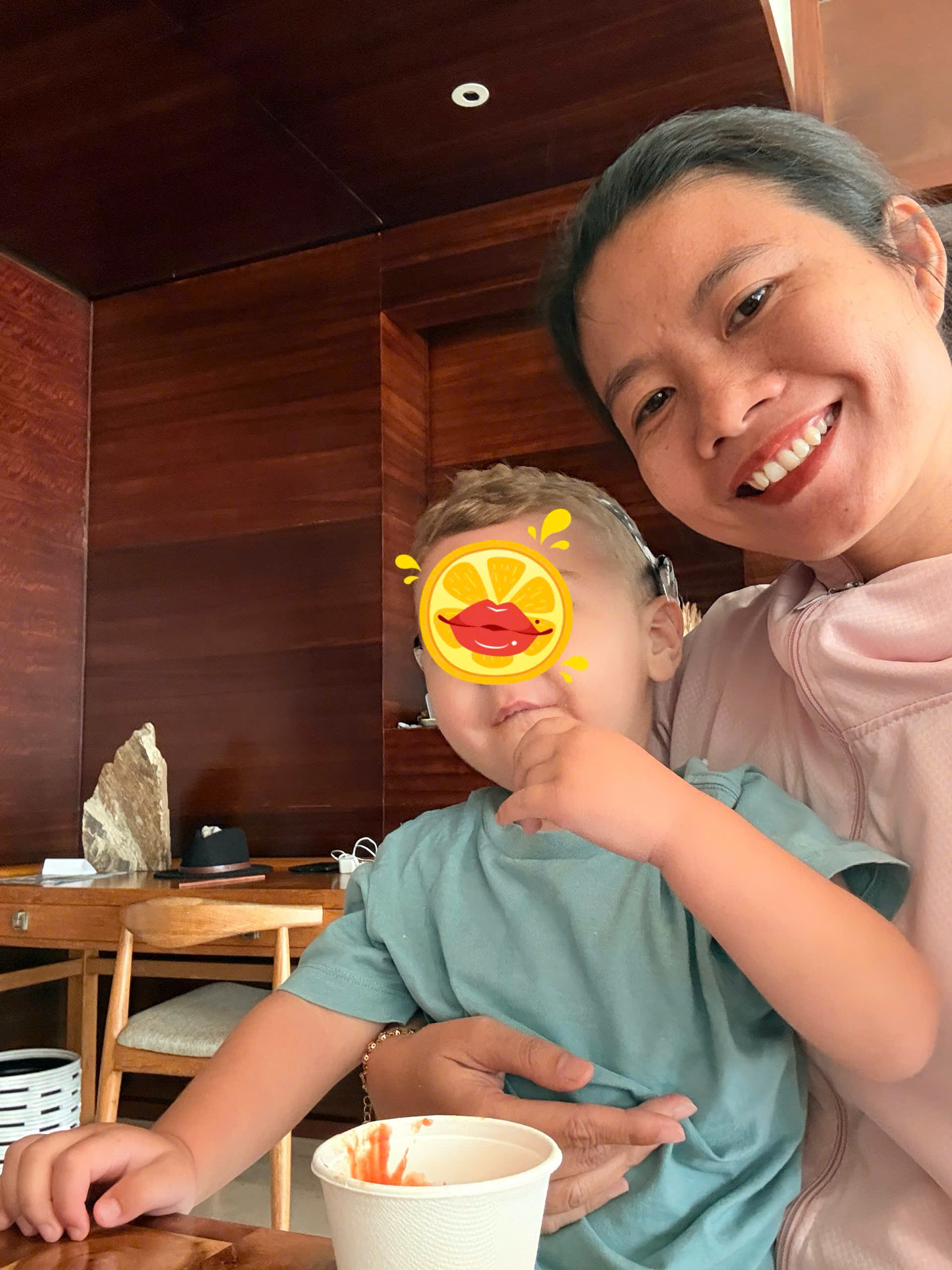 private nanny caring for a happy toddler in a luxury room at Pullman Danang Beach Resort
