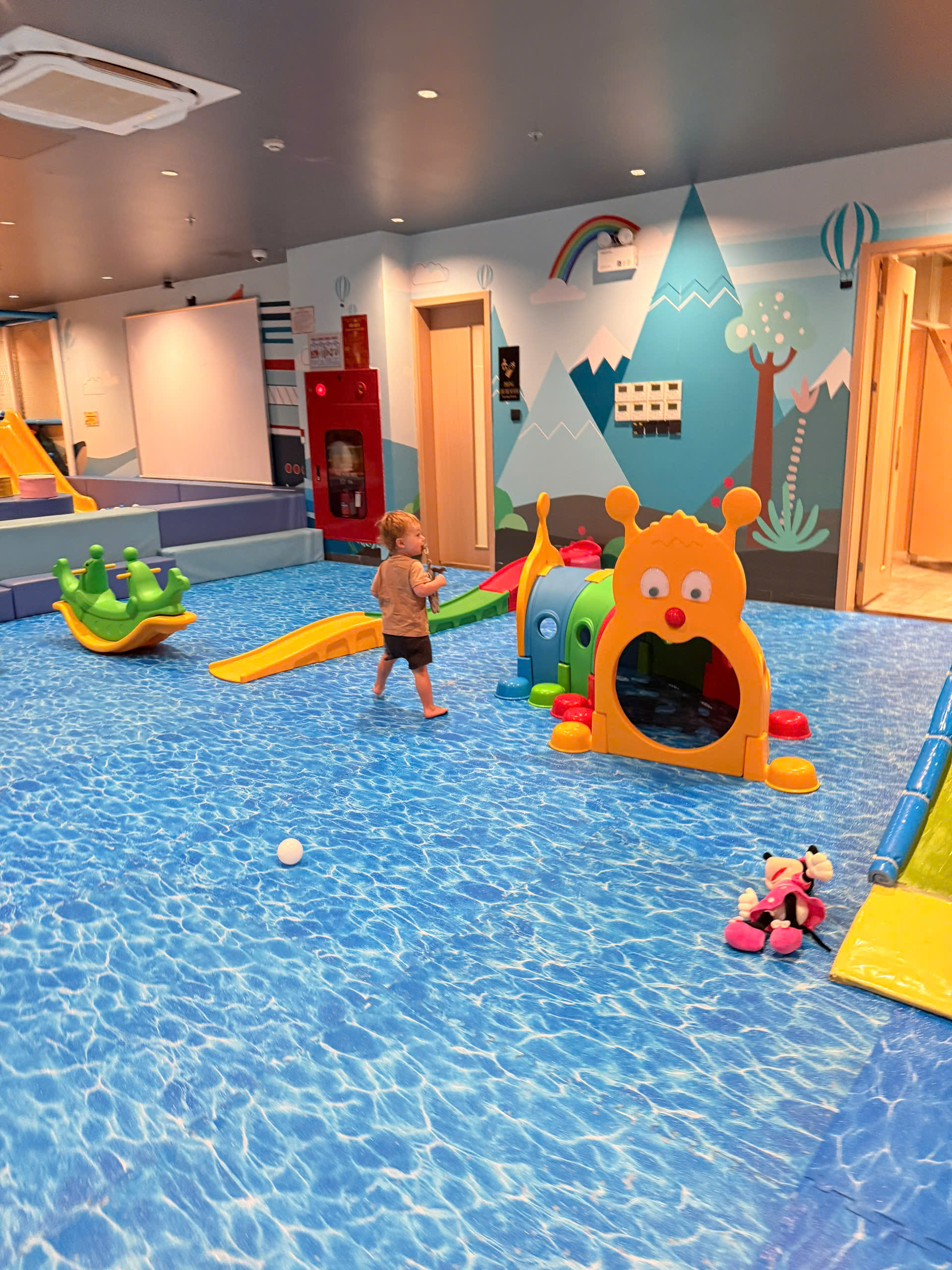 Babysitter helping a child with calm activity during travel childcare