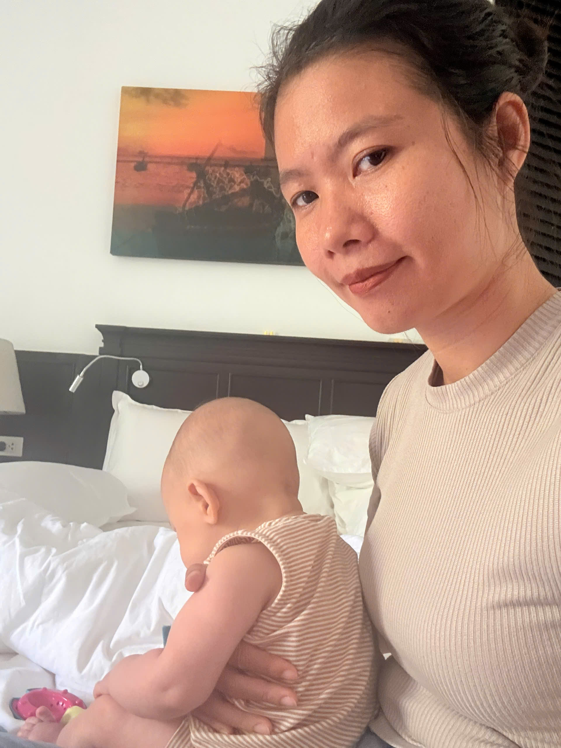 babysitter supporting toddler mealtime in hotel suite
