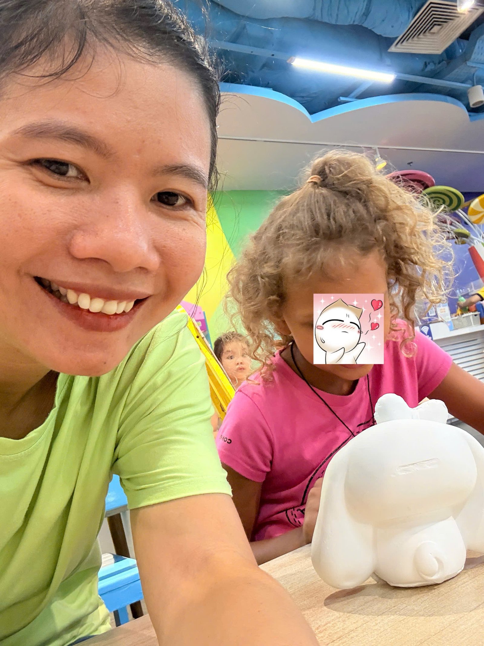 Hanna smiling and interacting with Annie during childcare at Funny Kid Da Nang
