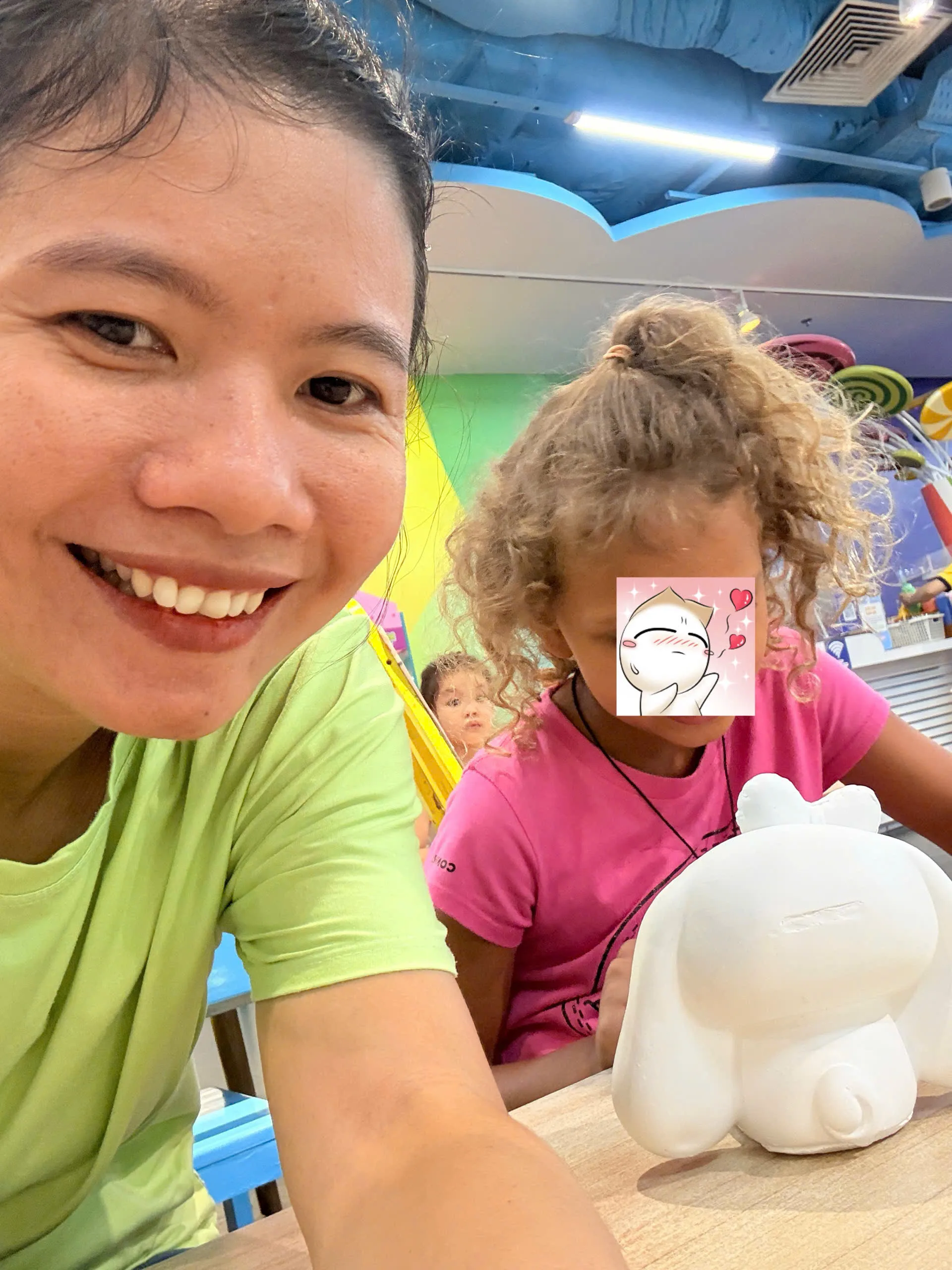 Hanna smiling and interacting with Annie during childcare at Funny Kid Da Nang